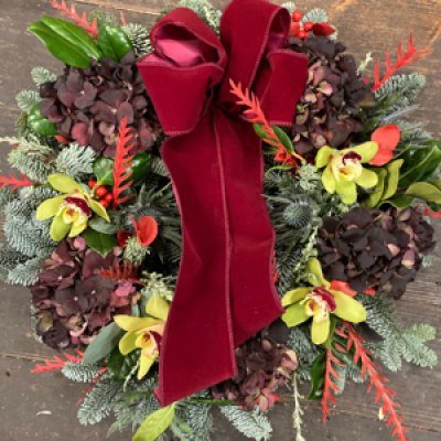 Fresh Door Wreaths - This beautiful wreath is suitable to attach to the door or use as an indoor Christmas arrangement. Filled with seasonal foliage and quality flowers. Complete with a rich velvet bow